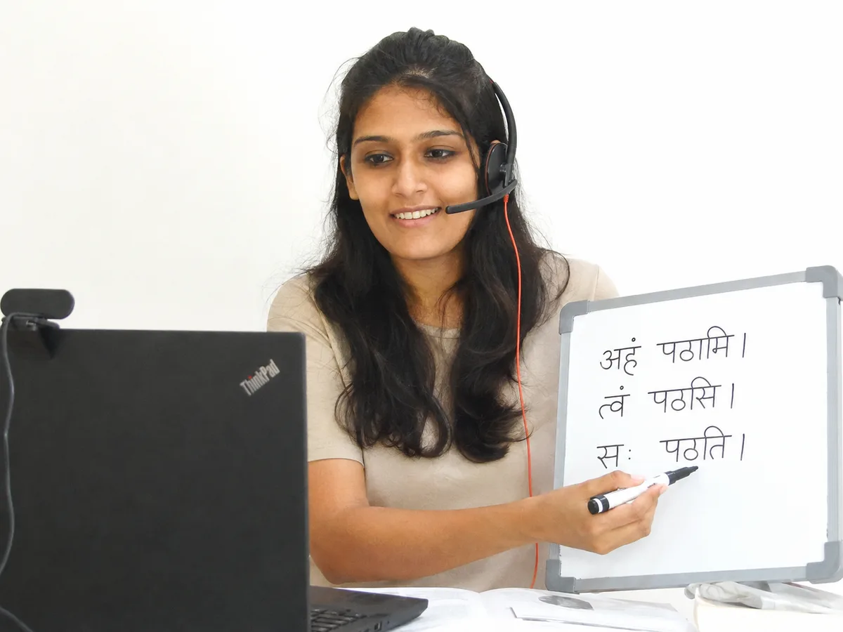 Ms. Ishita Parikh teaching Sanskrit on a whiteboard in a live online class